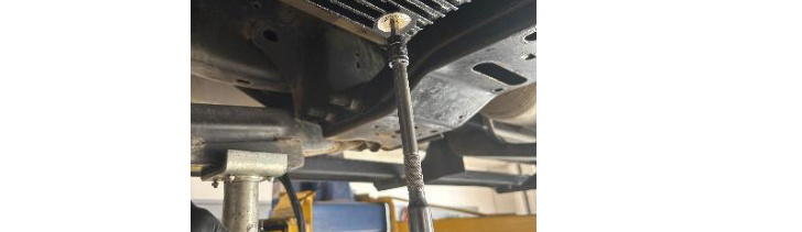 Installing the magnetic drain plug with a 5/16 inch Allen driver