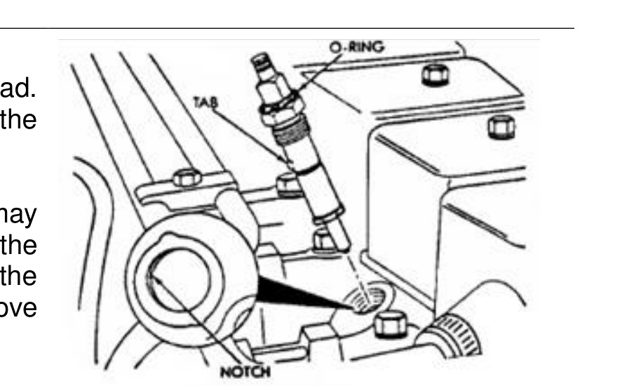 Aligning the injector tab with the notch in the cylinder bore