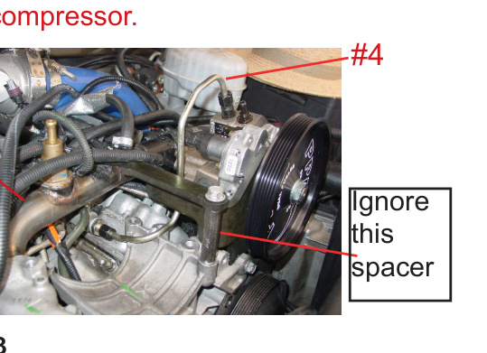 High pressure steel line routed under the A/C compressor area, with water line W and spacer noted